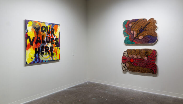 three large works hanging in the gallery